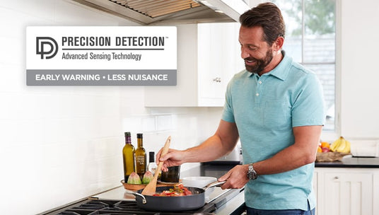Man cooking at stove in kitchen