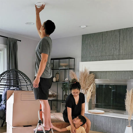 Home owner is installing a smoke alarm